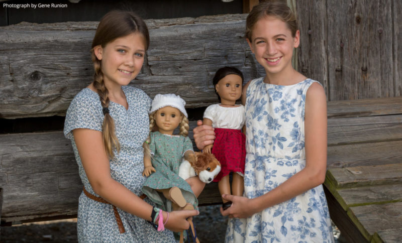 Girls holding American Girl dolls